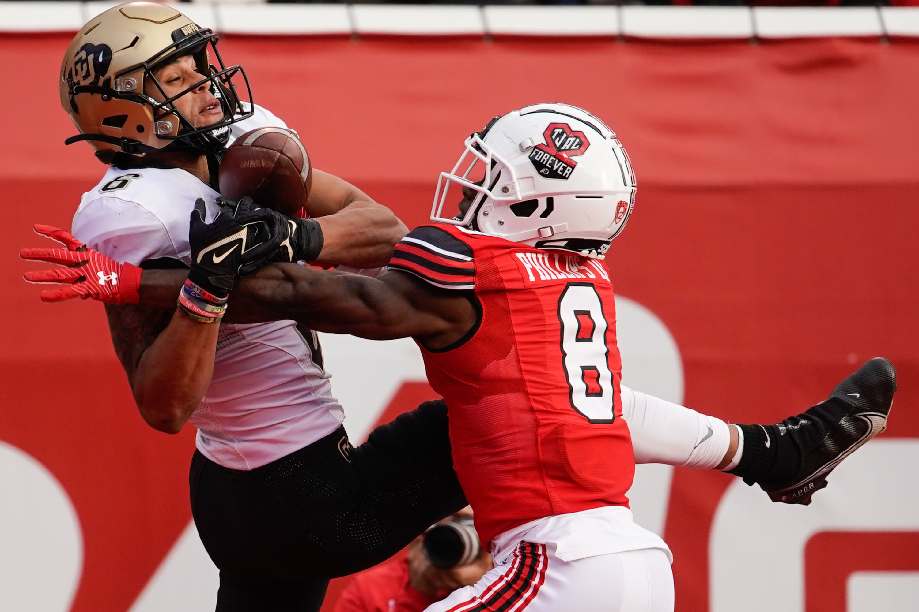 Colorado wide receiver Daniel Arias (6) misses to catch a pass as Utah cornerback Clark Phillips III (8) intercepts in an NCAA football game at Rice-Eccles Stadium in Salt Lake City on Friday, Nov. 26, 2021.