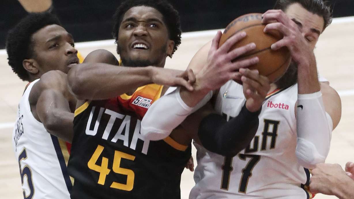 New Orleans Pelicans forward Herbert Jones (5), Utah Jazz guard Donovan Mitchell (45), and New Orleans Pelicans center Jonas Valanciunas (17) fight for the rebound during an NBA game at the Vivint Arena in Salt Lake City on Friday, Nov. 26, 2021. The Jazz lost 97-98.