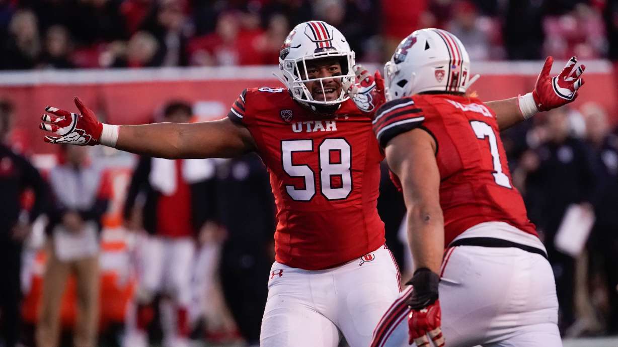 Utah defensive tackle Junior Tafuna, left and Utah defensive end Van Fillinger celebrate against Colorado in an NCAA football game at Rice-Eccles Stadium in Salt Lake City on Friday, Nov. 26, 2021.