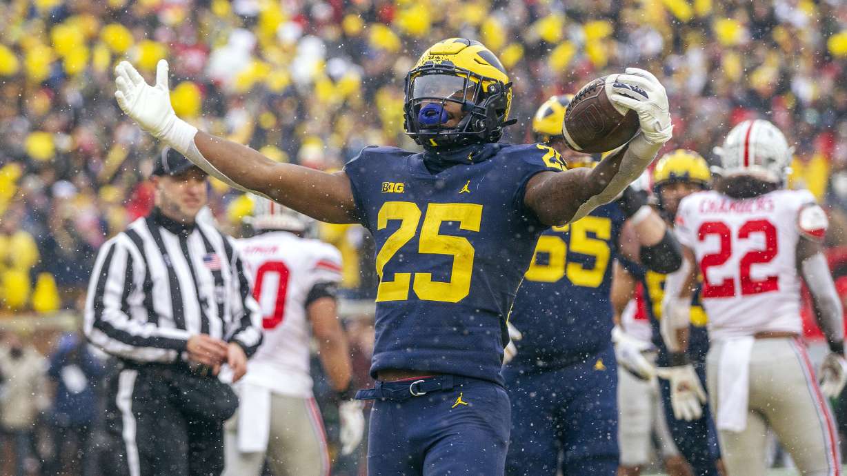 Michigan running back Hassan Haskins (25) celebrates a touchdown in the fourth quarter of an NCAA college football game against Ohio State in Ann Arbor, Mich., Saturday, Nov. 27, 2021. Michigan won 42-27.