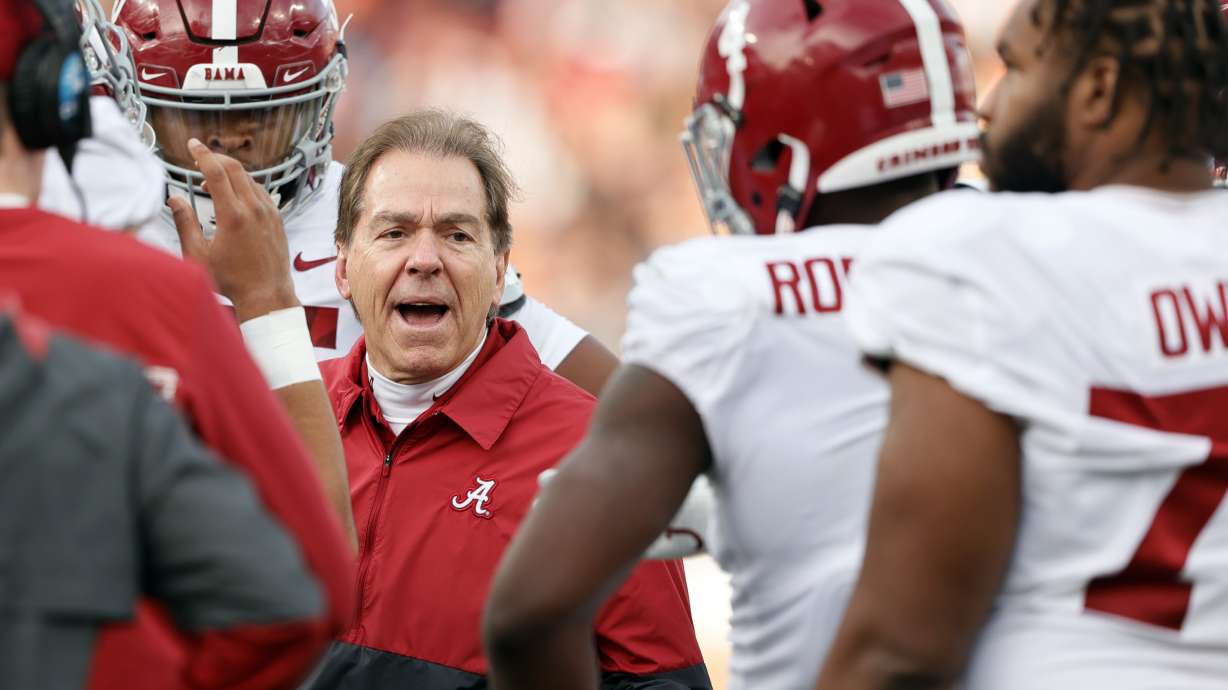 Alabama head coach Nick Saban talks with players in a time out during the first half of an NCAA college football game against Auburn Saturday, Nov. 27, 2021, in Auburn, Ala.