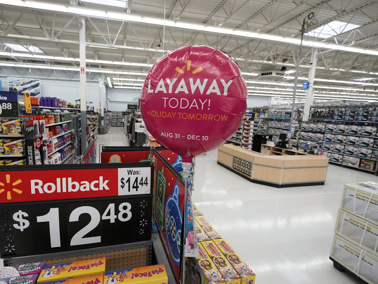 Signs promote sales and layaway inside a Walmart Supercenter on Nov. 9, 2018, in Houston. A tech-driven
option that occupies a sort-of middle ground between layaway and in-store financing is on the rise.