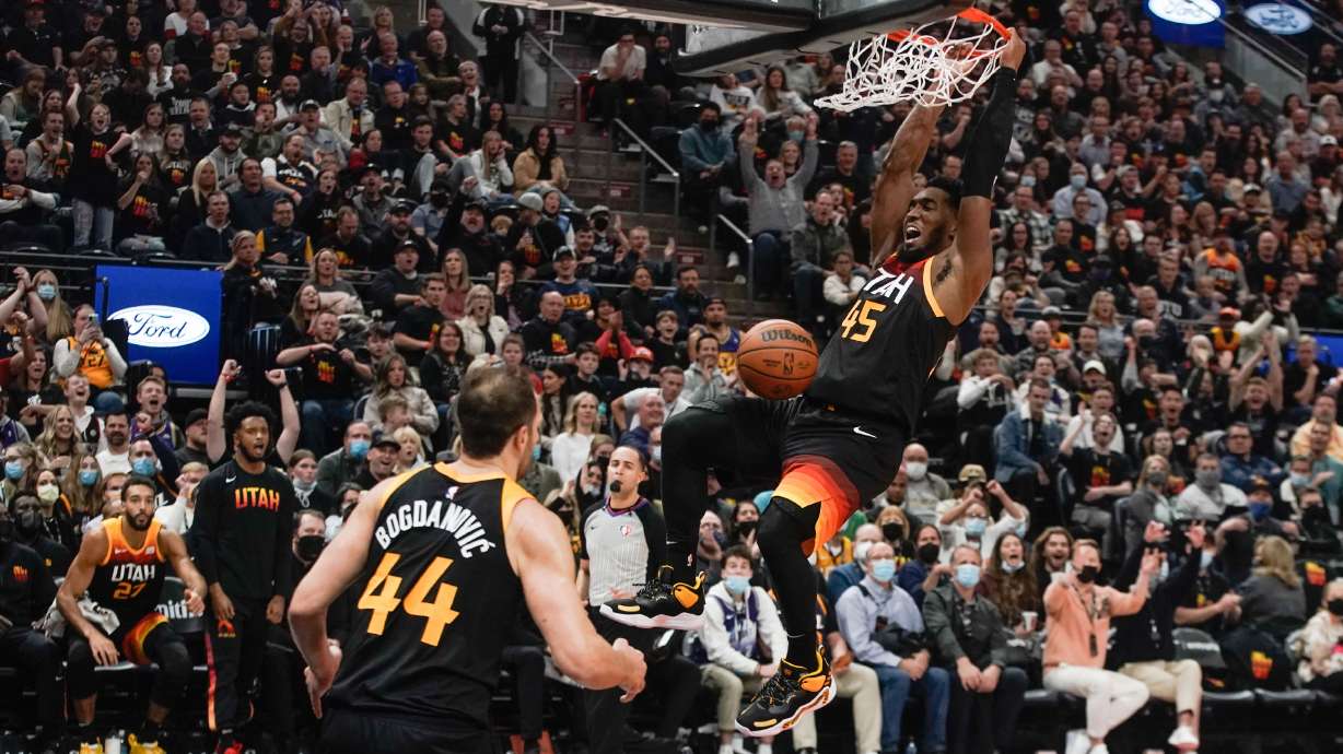 Utah Jazz guard Donovan Mitchell, right, dunks as Utah Jazz forward Bojan Bogdanovic watches during an NBA game against the New Orleans Pelicans at Vivint Arena in Salt Lake City on Saturday, Nov. 27, 2021.