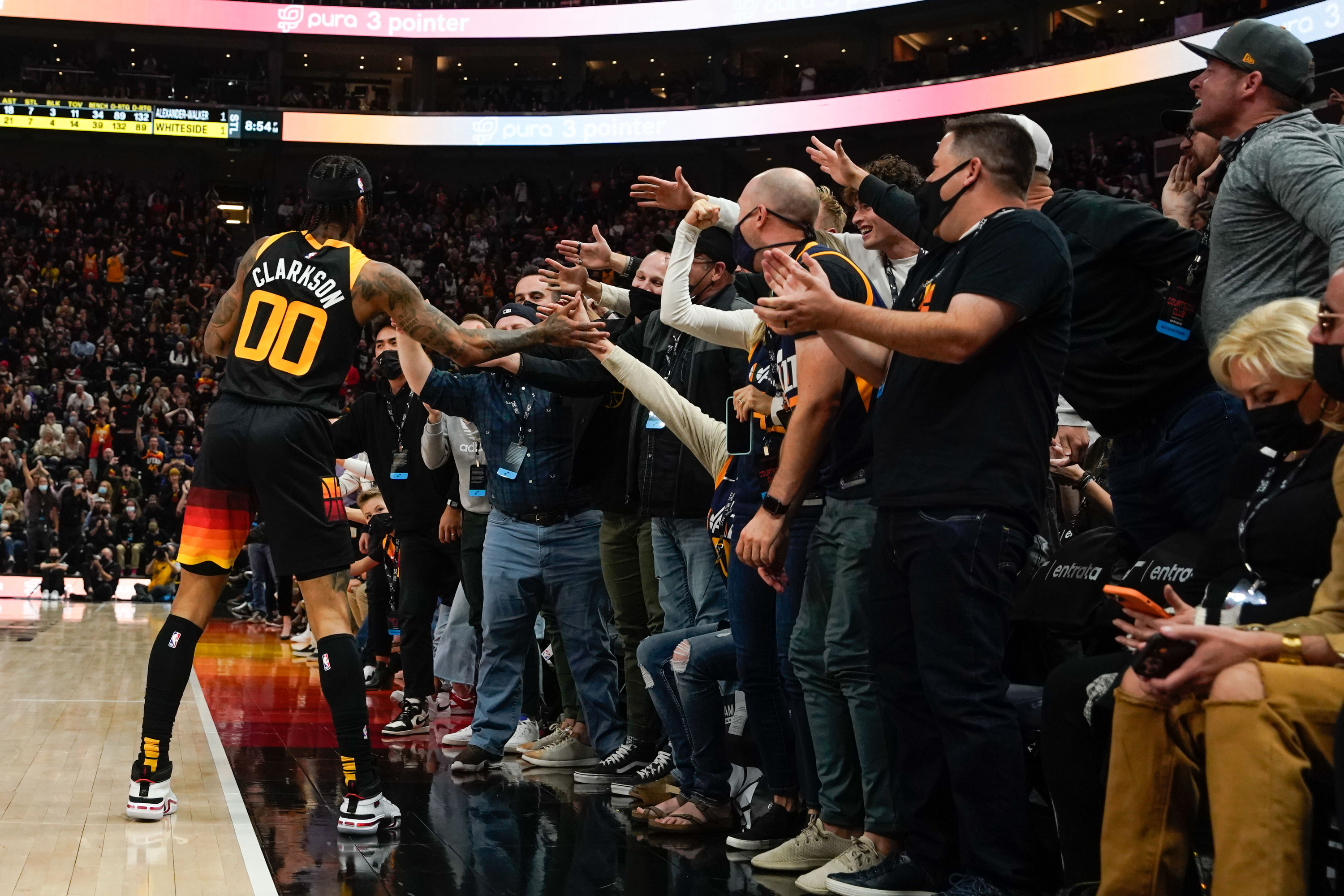 Utah Jazz guard Jordan Clarkson high-fives with fans after scoring a 3-pointer against the New Orleans Pelicans during an NBA game at Vivint Arena in Salt Lake City on Saturday, Nov. 27, 2021.