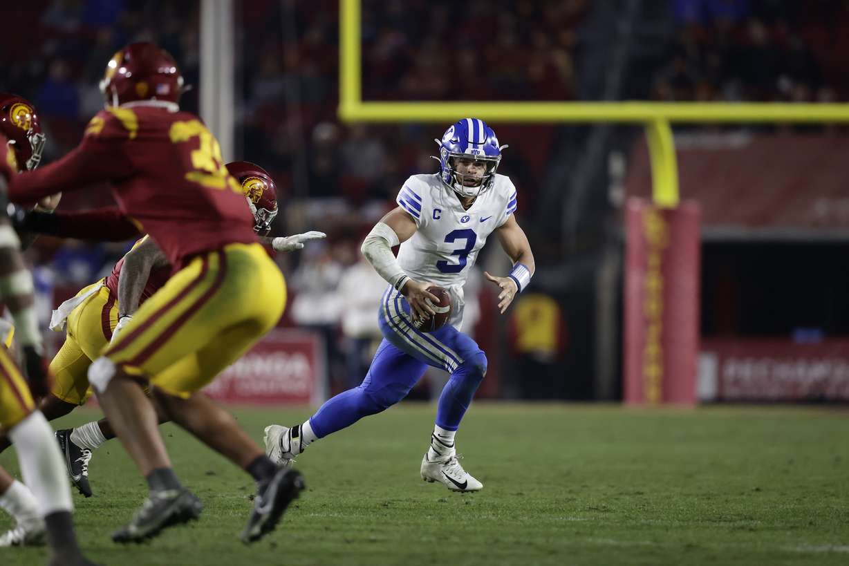 BYU quarterback Jaren Hall scrambles while looking downfield during an NCAA college football game against USC, Saturday, Nov. 27, 2021 in the Los Angeles Memorial Coliseum.