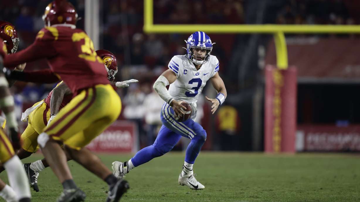BYU quarterback Jaren Hall scrambles while looking downfield during an NCAA college football game against USC, Saturday, Nov. 27, 2021 in the Los Angeles Memorial Coliseum.