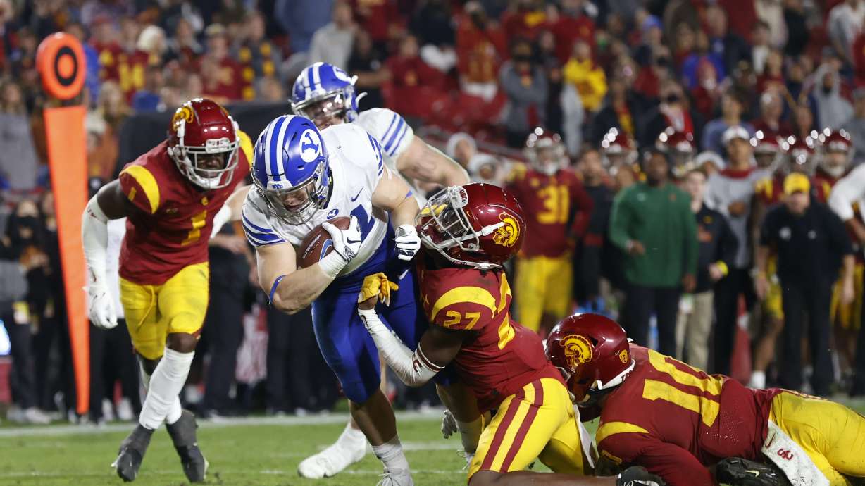 BYU running back Jackson McChesney scores the go-ahead touchdown on a 7-yard run against USC in an NCAA college football game, Saturday, Nov. 27, 2021 at the Los Angeles Memorial Coliseum.