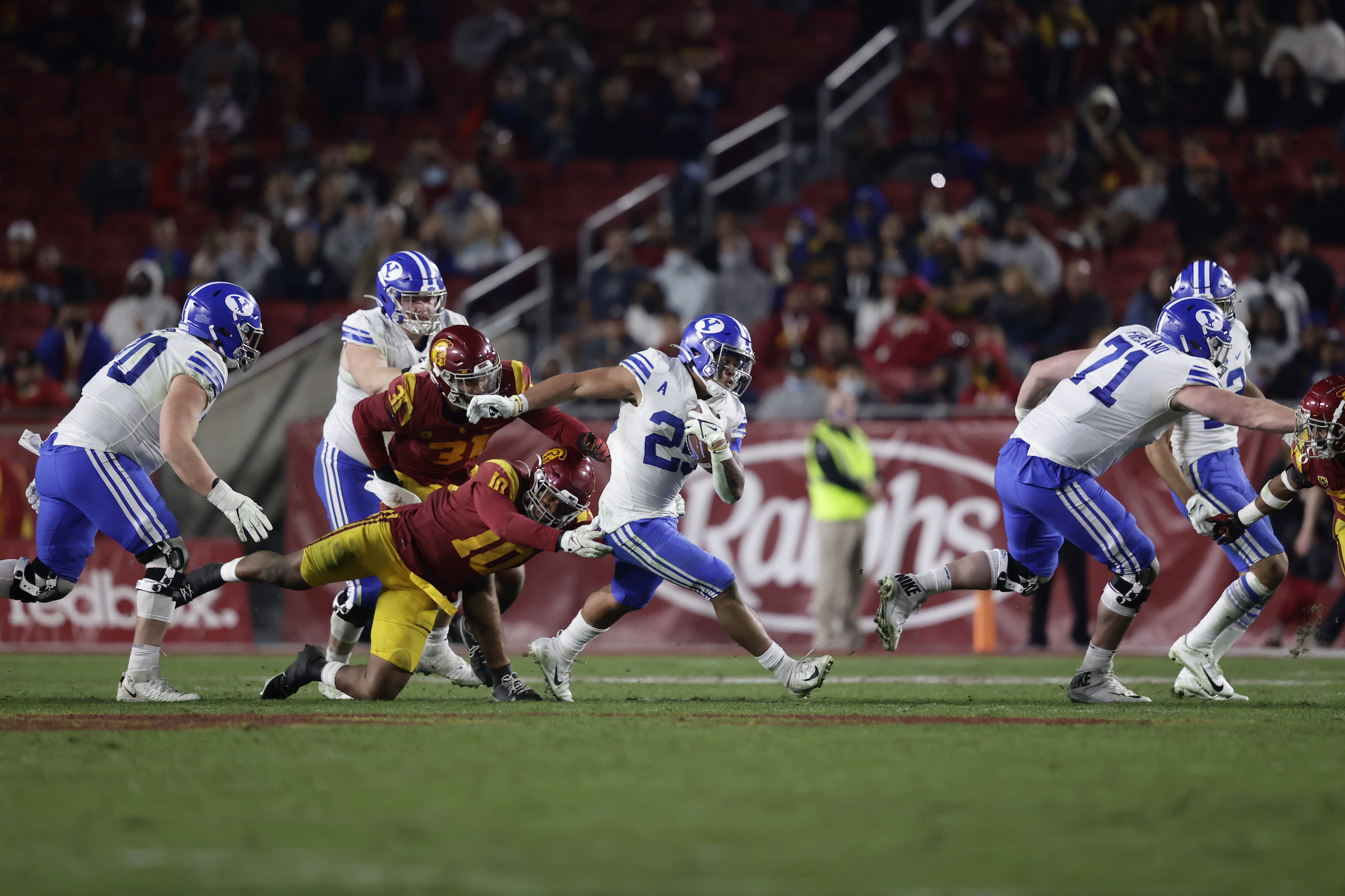 BYU running back Tyler Allgeier runs for yardage against USC during an NCAA college football game, Saturday, Nov. 27, 2021 in the Los Angeles Memorial Coliseum.