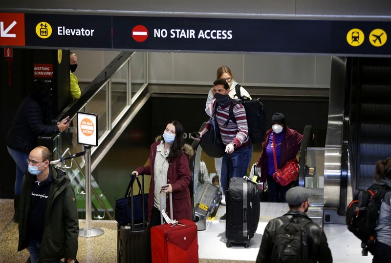People enter the baggage claim area from the international arrivals terminal as the U.S. reopens air and land borders to coronavirus disease vaccinated travelers for the first time since the COVID-19 restrictions were imposed, at Sea-Tac Airport in Seattle, on Nov. 8.