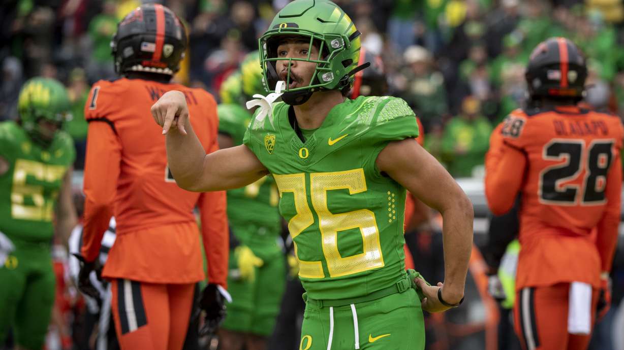 Oregon running back Travis Dye (26) celebrates a touchdown during the first quarter of an NCAA college football game against Oregon State, Saturday, Nov. 27, 2021, in Eugene, Ore.
