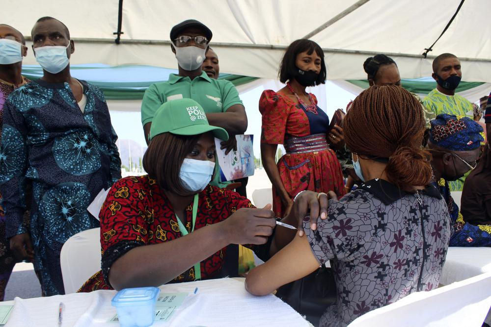 A woman receives an AstraZeneca coronavirus vaccine in Abuja, Nigeria, on Nov 19. The emergence of the new omicron variant and the world’s desperate and likely futile attempts to keep it at bay are reminders of what scientists have warned for months: The coronavirus will thrive as long as vast parts of the world lack vaccines.