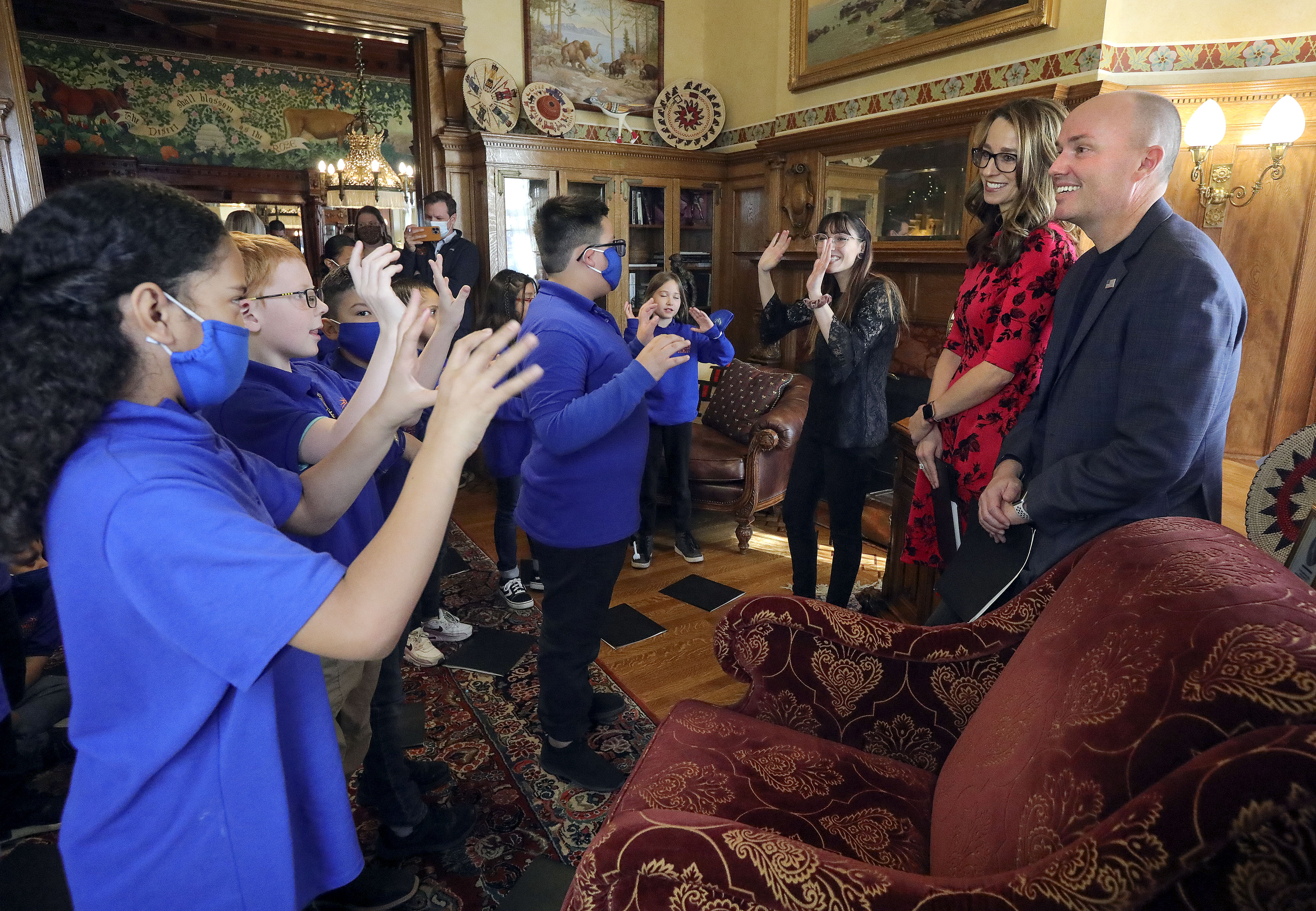 Fourth graders from Wallace Stegner Academy sing to Utah first lady Abby Cox and Gov. Spencer Cox at the Governor’s Mansion in Salt Lake City on Monday. They sang a Christmas song as well as an original song they wrote about their school.