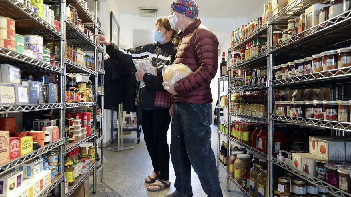 Laurie Humbert and Kenny Beoettger shop at Caputo’s Market & Deli in Salt Lake City on Nov. 24, 2021. Experts think that despite concerns about inflation that market trends will continue to display retail sales as up when the market report is released.
