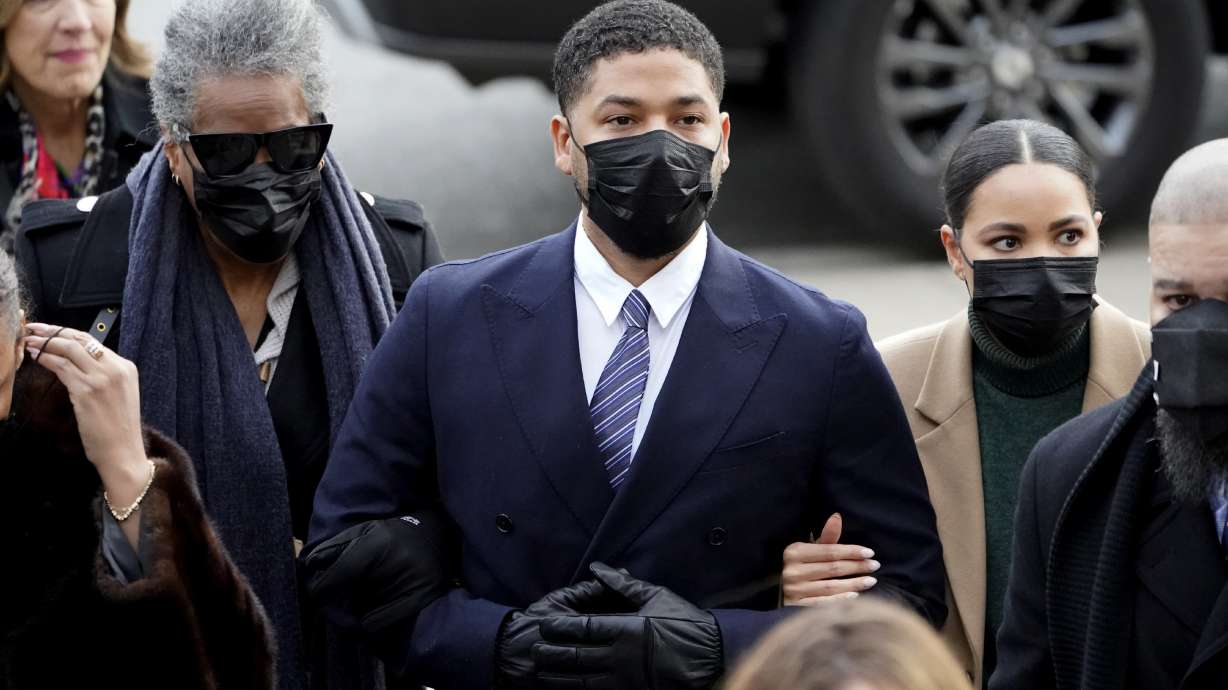 Actor Jussie Smollett walks with family members as they arrive Monday at the Leighton Criminal Courthouse for jury selection at his trial in Chicago. Smollett is accused of lying to police when he reported he was the victim of a racist, anti-gay attack in downtown Chicago nearly three years ago.