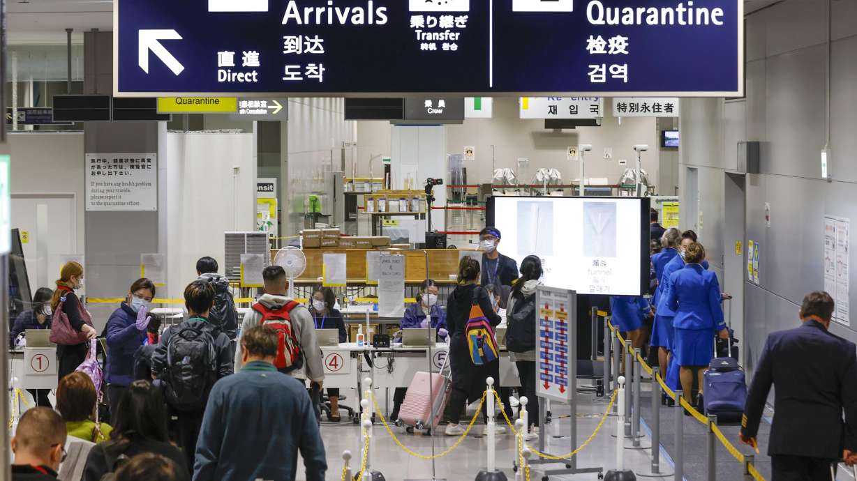 Passengers wait in a line to receive quarantine test on their arrivals at Kansai International Airport in Osaka, western Japan, Tuesday. The omicron variant was already in the Netherlands when South Africa alerted the World Health Organization about it last week, Dutch health authorities said Tuesday.