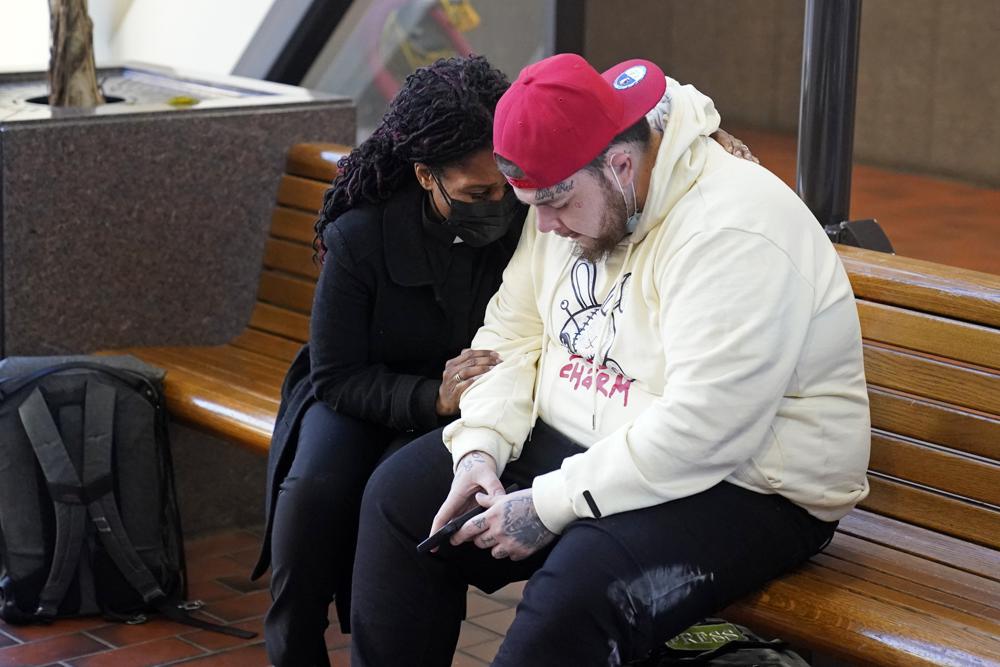 An unidentified member of the clergy, left, prays with Darnik Wright, the brother of Daunte Wright, Tuesday at the Hennepin County Government Center in Minneapolis prior to the start of jury selection for former suburban Minneapolis police officer Kim Potter. Potter says she meant to grab her Taser instead of her handgun when she shot and killed motorist Daunte Wright on April 11, 2021.