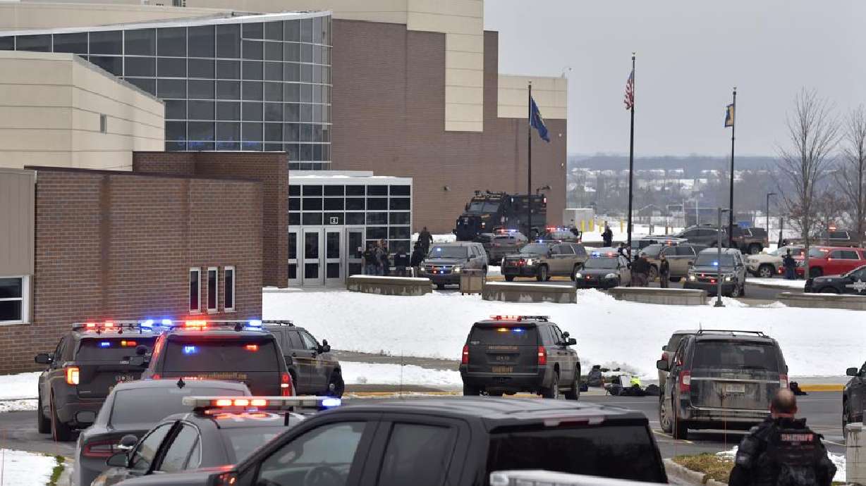Dozens of police, fire, and EMS personnel work on the scene of a shooting at Oxford High School, Tuesday, in Oxford Township, Mich.