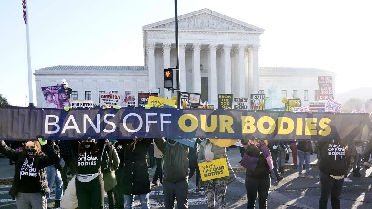People demonstrate in front of the U.S. Supreme Court Wednesday, in Washington, as the court hears arguments in a case from Mississippi, where a 2018 law would ban abortions after 15 weeks of pregnancy, well before viability.