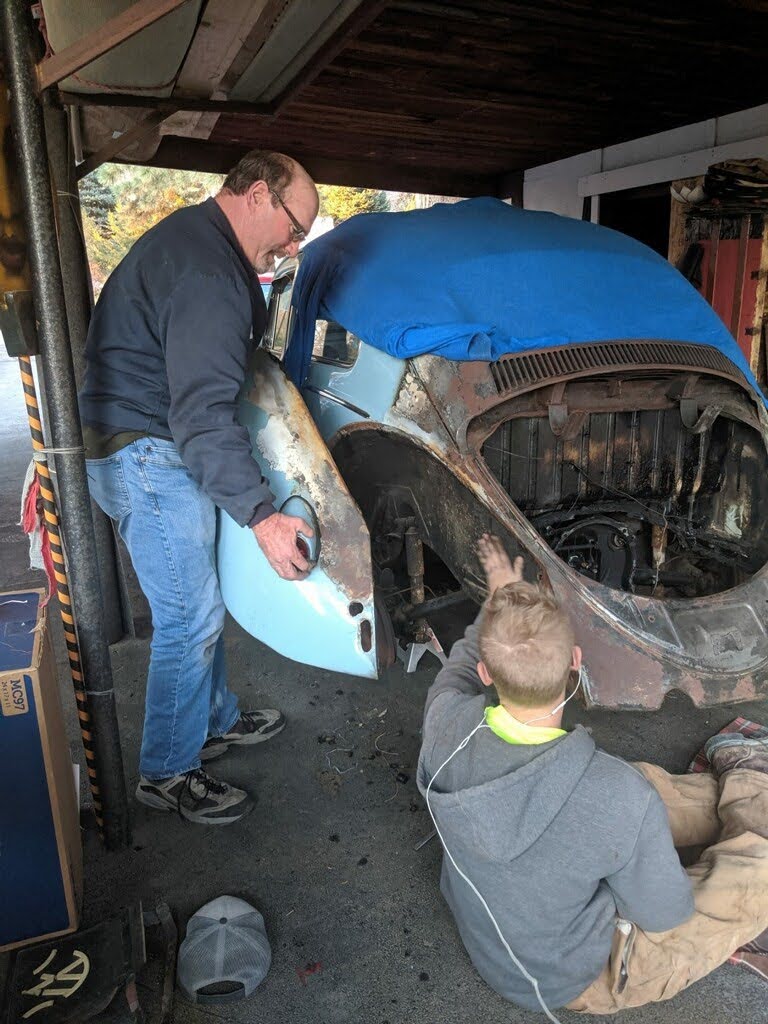 Members of the Voodoo Kruizerz VW Car Club get to work on Ann Argyle's Beetle to repair the fire damage.