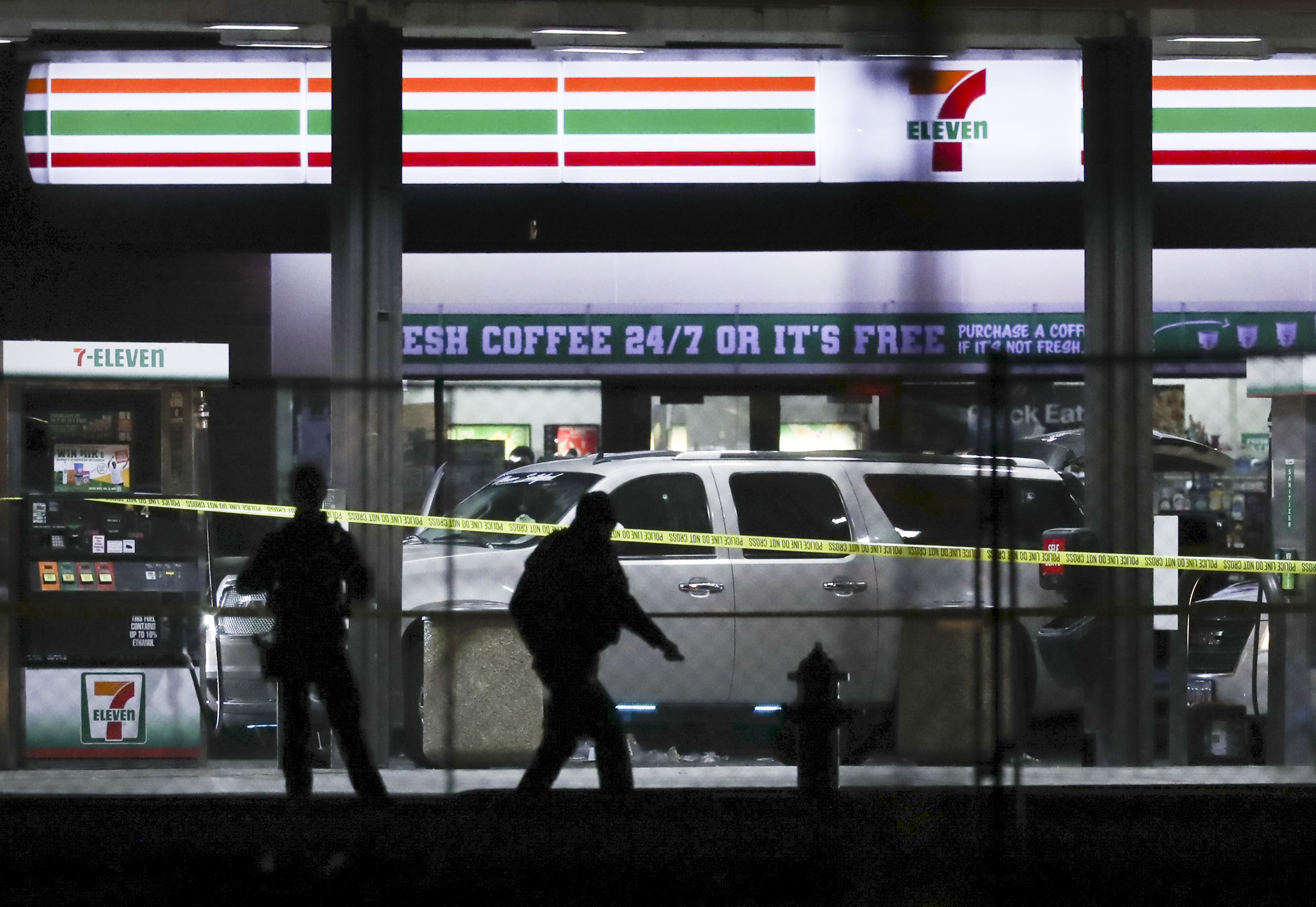 Crime tape and a heavy police presence surround a 7-Eleven in Taylorsville on Dec. 1, 2021. The district attorney determined Friday that 11 officers were legally justified in shooting and killing a gunman in a shootout there that also injured three officers.