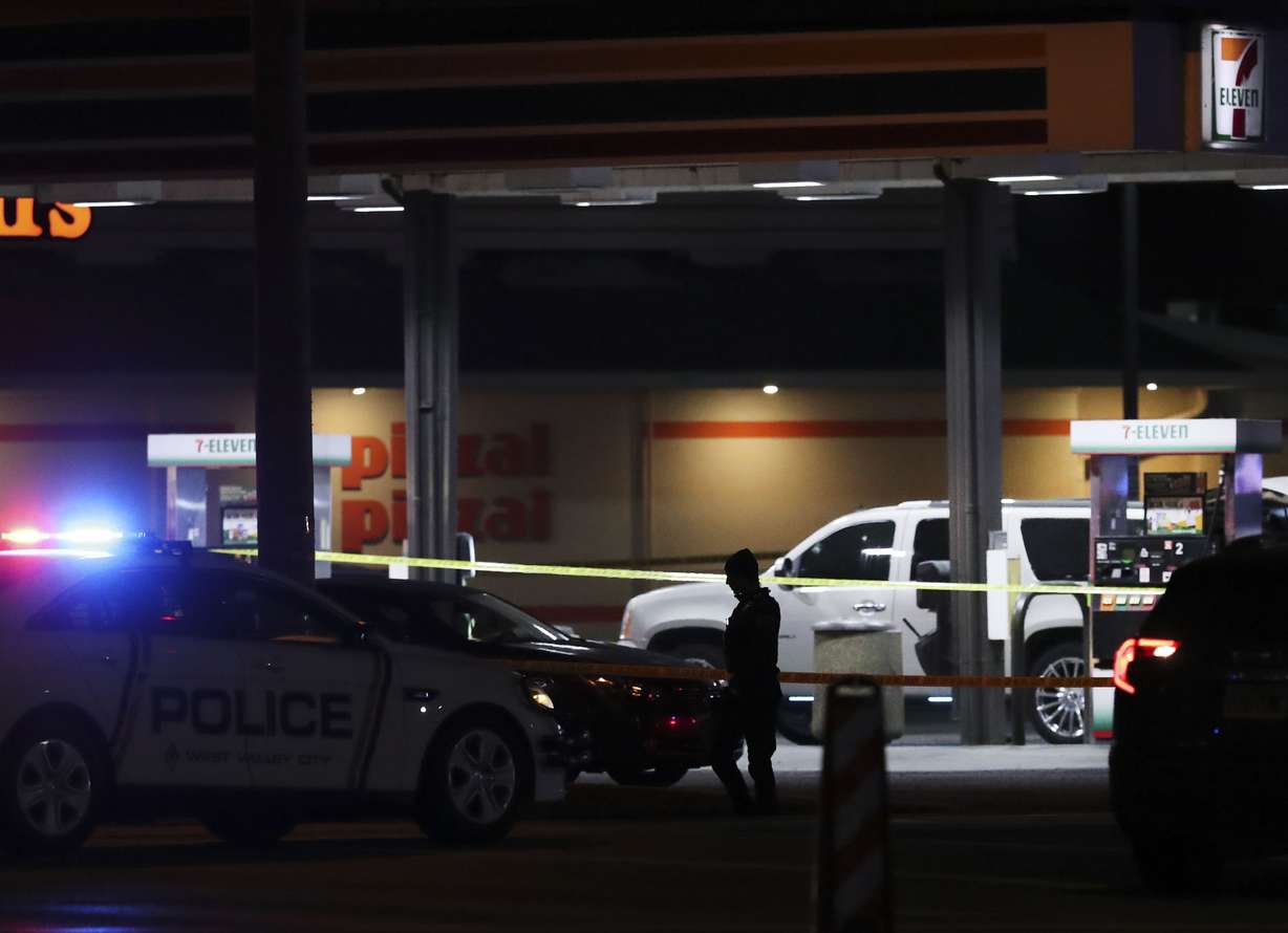 Crime tape and a heavy police presence surround a 7-Eleven in Taylorsville on Wednesday. Two police officers and a suspect were shot while exchanging gunfire at 4110 S. Redwood Road.