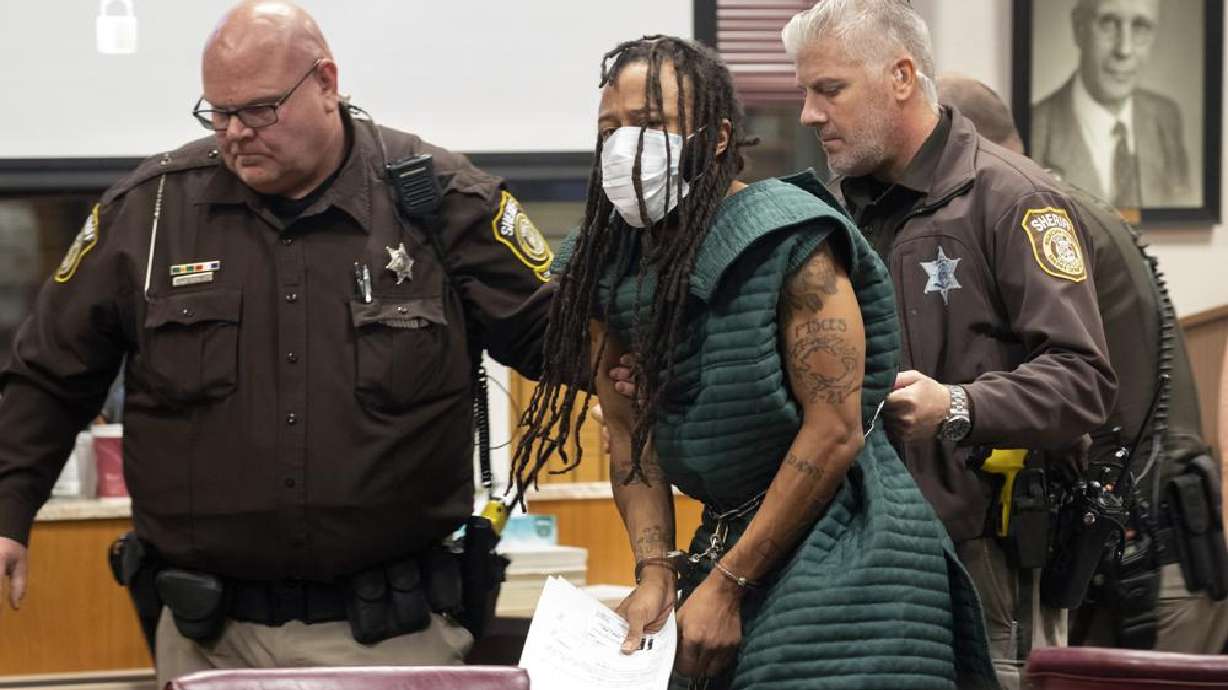 Darrell Brooks, center, is escorted out of the courtroom after making his initial appearance, Tuesday, Nov. 23, in Waukesha County Court in Waukesha, Wis. Prosecutors in Wisconsin have charged Brooks with intentional homicide in the deaths of at least five people who were killed when an SUV was driven into a Christmas parade.