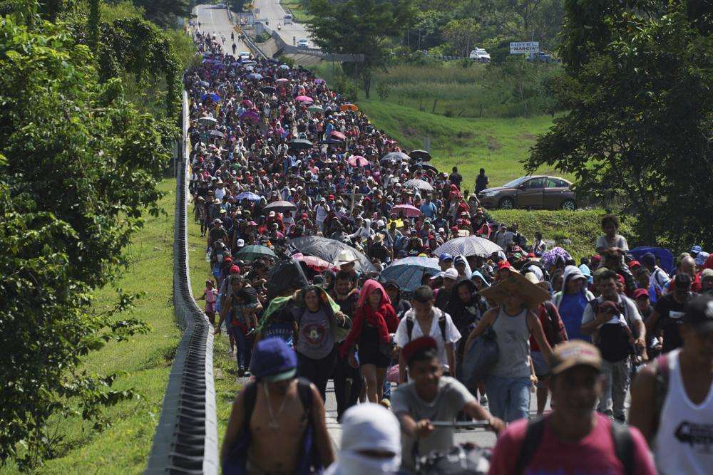 Migrants arrive in Villa Comaltitlan, Chiapas state, Mexico, Oct. 27, as they continue their journey through Mexico to the U.S. border. The Biden administration struck agreement with Mexico to reinstate a Trump-era border policy next week that forces asylum-seekers to wait in Mexico for hearings in U.S. immigration court, U.S. officials said Thursday.