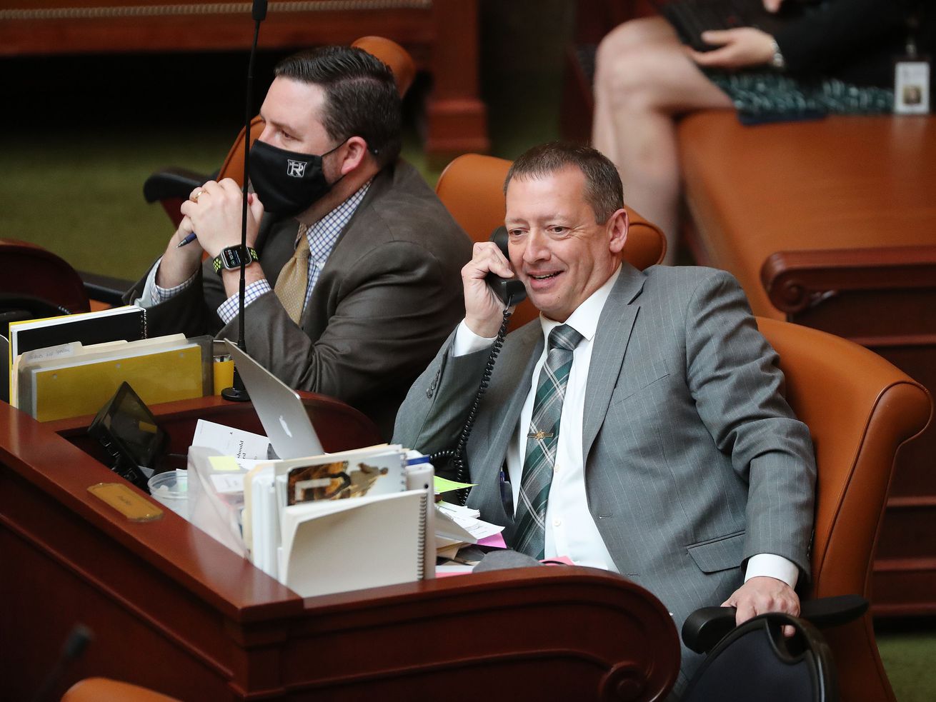 Rep. Paul Ray, R-Clearfield, right, talks on the phone during the Utah Legislature’s 2021 general session at the Capitol in Salt Lake City on March 3, 2021.Ray will resign from the Utah
House of Representatives to accept a position as the assistant director of legislative affairs for the Utah Department of Health and Human Services. 