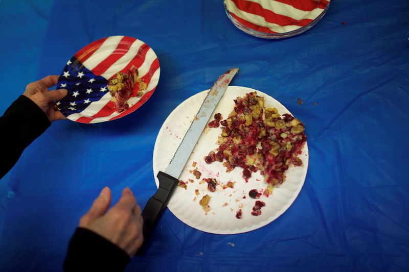Volunteer Anne Scerbo places a piece of cranberry cake onto a U.S. flag themed paper plate during a break from phone calls at the York County Democratic Headquarters in York, Pennsylvania, Nov. 4, 2014. Researchers estimate U.S. food loss to be in the range of 73 to 152 million metric tons per year,
