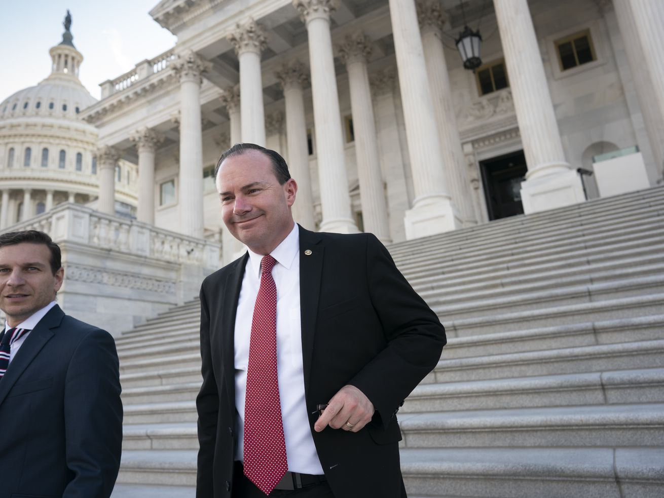 Sen. Mike Lee, R-Utah, right, leaves a private GOP lunch meeting as he continues to press for a vote on his proposal barring vaccine mandates that the Biden administration has
ordered for U.S. companies, at the Capitol in Washington Thursday.