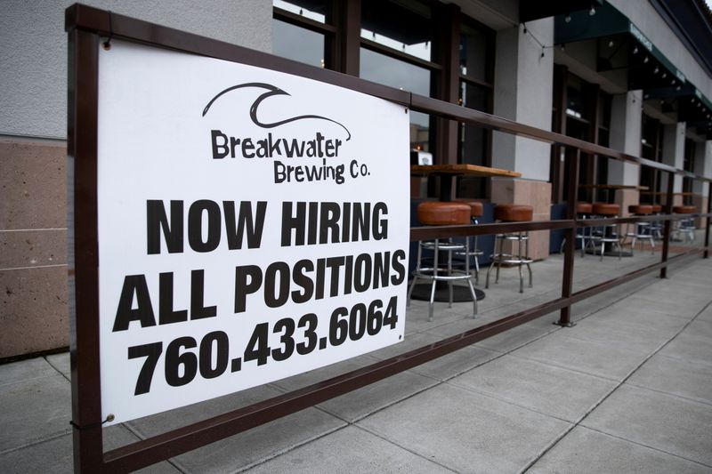 A restaurant advertising jobs looks to attract workers in Oceanside, California, May 10. Ermployment increased far less than expected in November as nonfarm payrolls increased by 210,000 jobs, the Labor Department said Friday.
