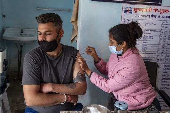 A man closes his eyes as he receives a Covishield vaccine for COVID-19 at a Primary Health Centre in Dharmsala, India, Friday.
