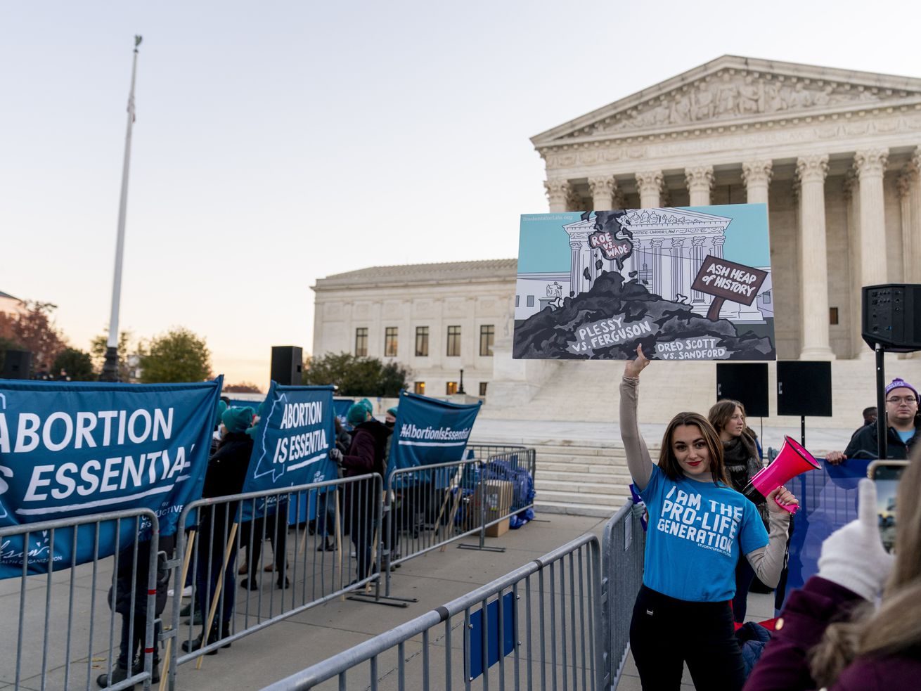 Abortion rights advocates and anti-abortion protesters demonstrate in front of the U.S. Supreme Court on Wednesday, in Washington, as the court hears arguments in a case from Mississippi, where a 2018 law would ban abortions after 15 weeks of pregnancy, well before viability. 