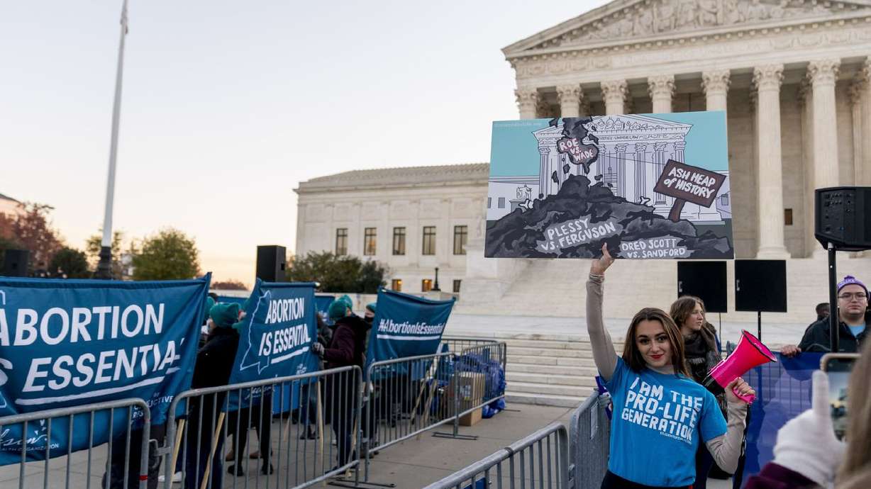 Abortion rights advocates and anti-abortion protesters demonstrate in front of the U.S. Supreme Court on Wednesday, in Washington, as the court hears arguments in a case from Mississippi, where a 2018 law would ban abortions after 15 weeks of pregnancy, well before viability.