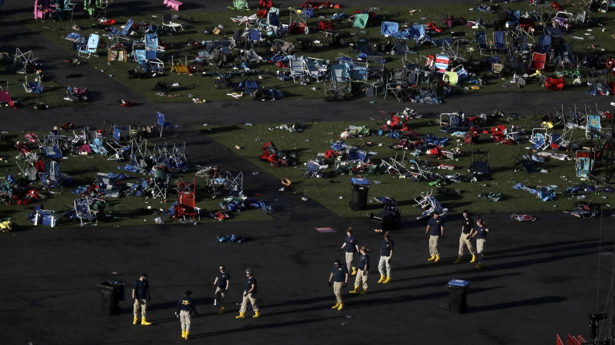 Investigators work at a festival grounds across the street from the Mandalay Bay Resort and Casino on Oct. 3, 2017, in Las Vegas after a mass shooting. The Nevada Supreme Court cited a state law that shields gun manufacturers from liability unless the weapon malfunctions in a new ruling that says they cannot be held responsible for the deaths in the 2017 mass shooting on the Las Vegas Strip.