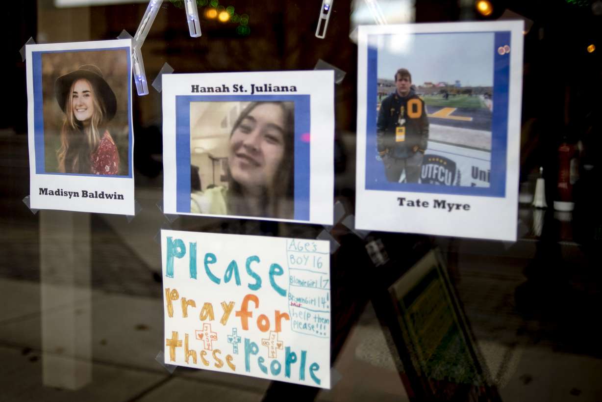 Photos of three of the four teens killed in the Oxford High School shooting are posted on the window at Sullivan's Public House Restaurant and Bar on Thursday in Oxford, Mich. A 15-year-old sophomore opened fire at his Michigan high school on Tuesday, killing four students, including a 16-year-old boy who died in a deputy’s patrol car on the way to a hospital, authorities said.