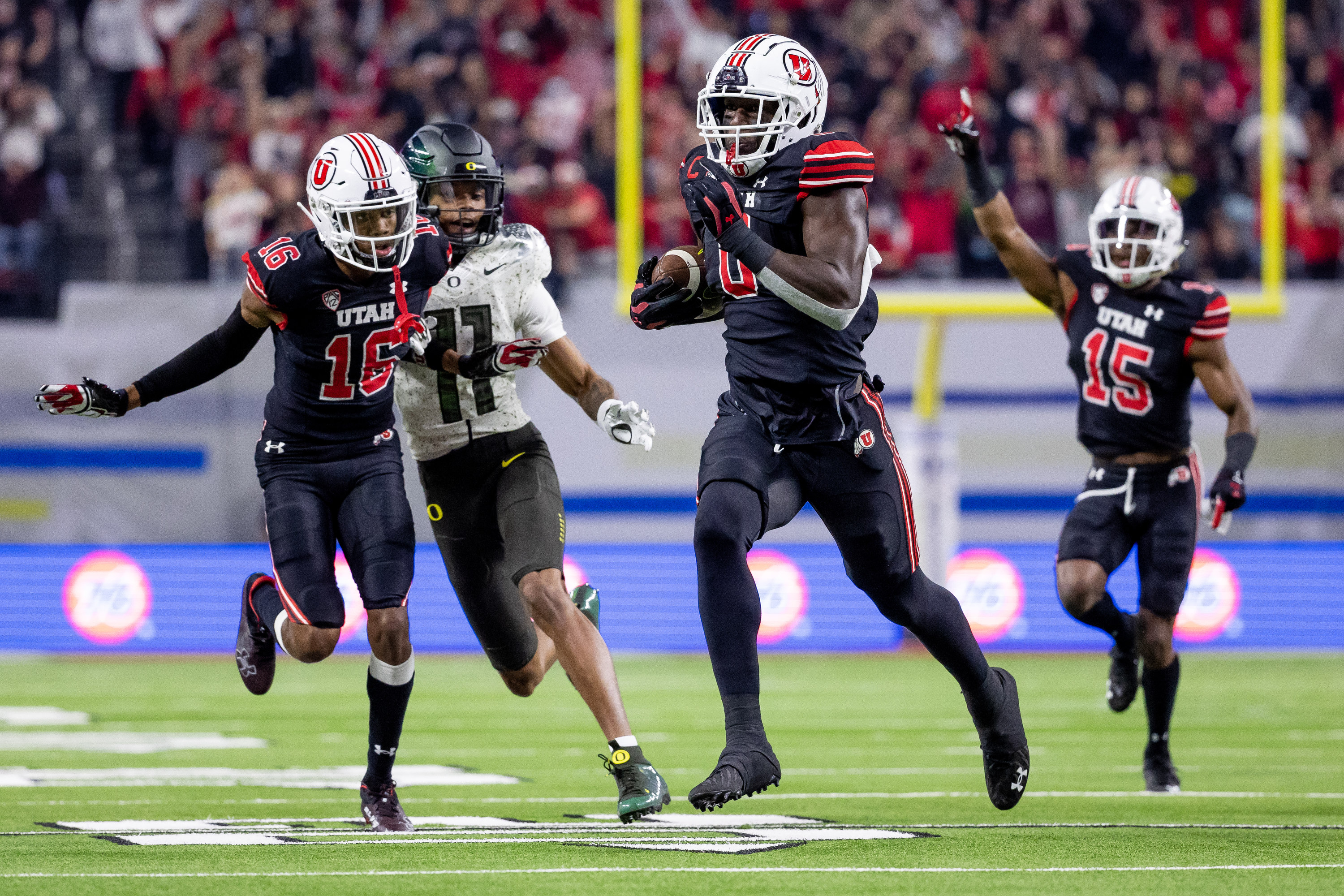 Utah Utes linebacker Devin Lloyd (0) runs back an intercepted pass to score, putting the Utes up 14-0 over the Oregon Ducks in the Pac-12 championship game at Allegiant Stadium in Las Vegas on Friday, Dec. 3, 2021.