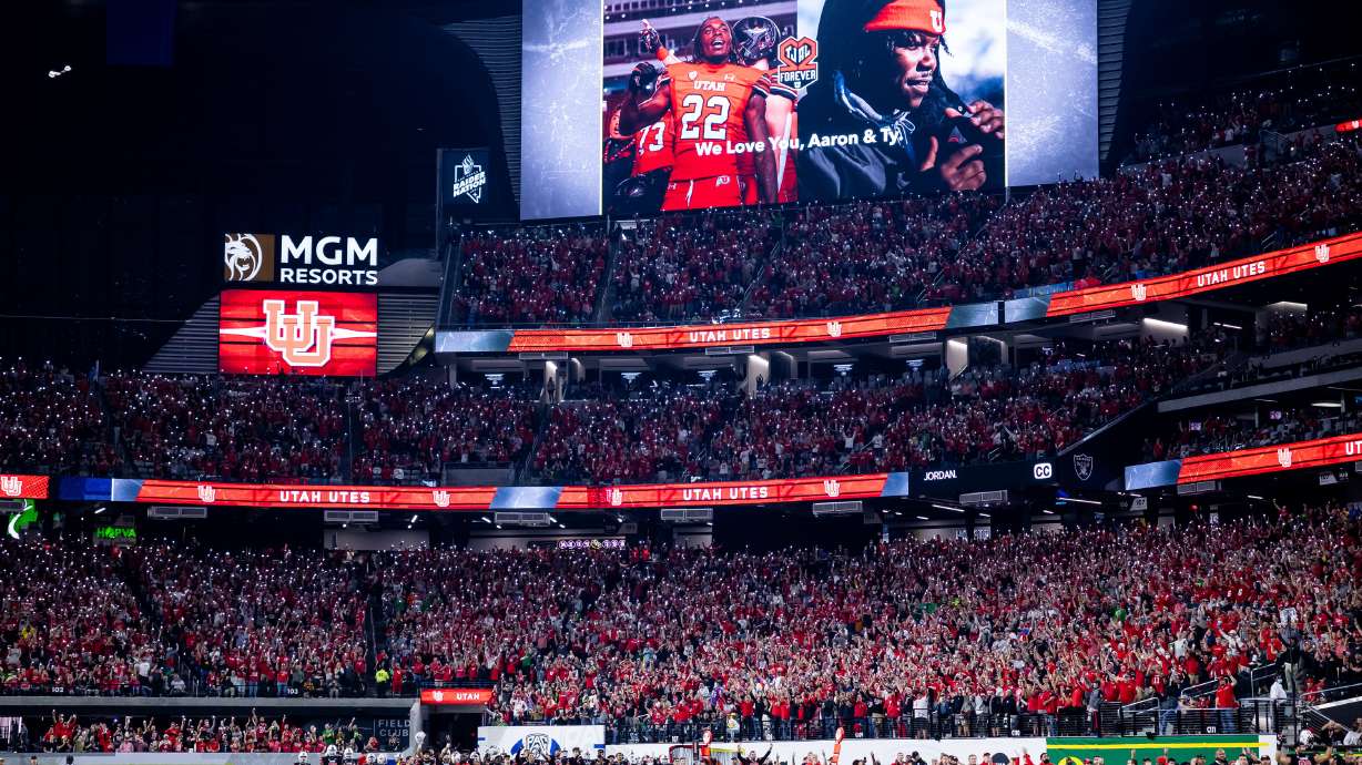 Utah Utes players and fans honor Aaron Lowe and Ty Jordan during the Pac-12 championship game against the Oregon Ducks at Allegiant Stadium in Las Vegas on Friday, Dec. 3, 2021.
