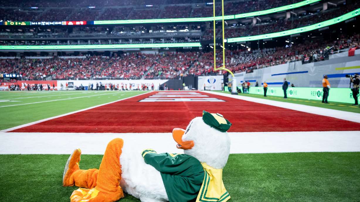 The Oregon Duck lays down on the field as the Ducks trail the Utah Utes during the Pac-12 championship game at Allegiant Stadium in Las Vegas on Friday, Dec. 3, 2021.