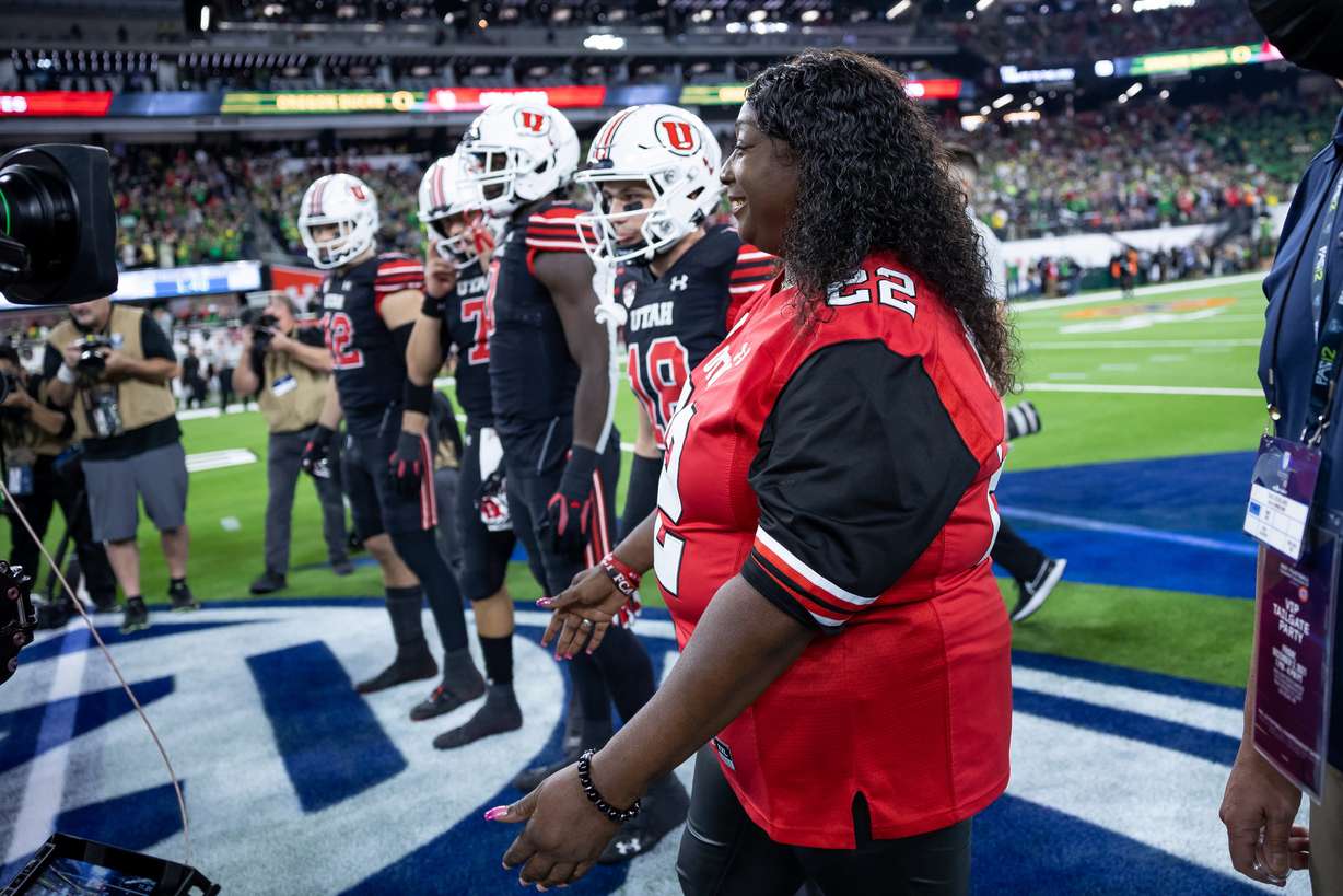 Donna Lowe-Sterns, mother of the late Utah player Aaron Lowe, serves as honorary captain during the coin toss before the Utah Utes play the Oregon Ducks in the Pac-12 championship game at Allegiant Stadium in Las Vegas on Friday, Dec. 3, 2021.