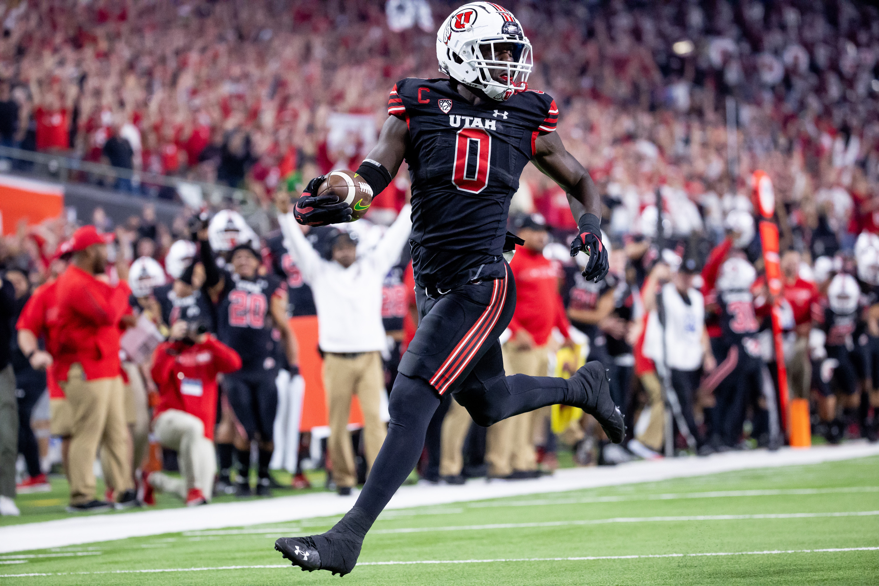 Utah Utes linebacker Devin Lloyd (0) runs back an intercepted pass to score, putting the Utes up 14-0 over the Oregon Ducks in the Pac-12 championship game at Allegiant Stadium in Las Vegas on Friday, Dec. 3, 2021.