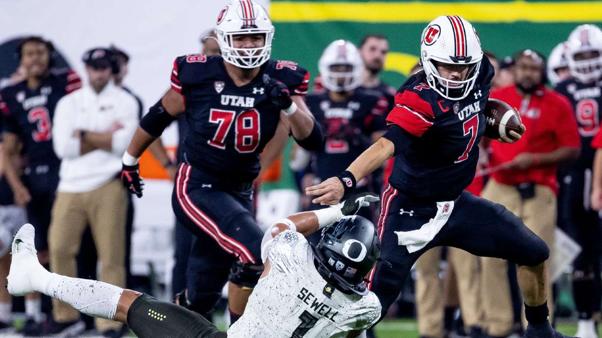 Utah Utes quarterback Cam Rising (7) evades the tackle from Oregon Ducks linebacker Noah Sewell (1) during the Pac-12 championship game at Allegiant Stadium in Las Vegas on Friday, Dec. 3, 2021.