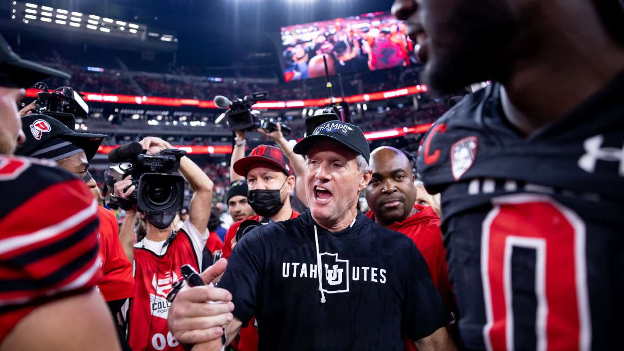 Utah Utes head coach Kyle Whittingham celebrates with players after the Utes beat the Oregon Ducks in the Pac-12 championship game at Allegiant Stadium in Las Vegas on Friday, Dec. 3, 2021.