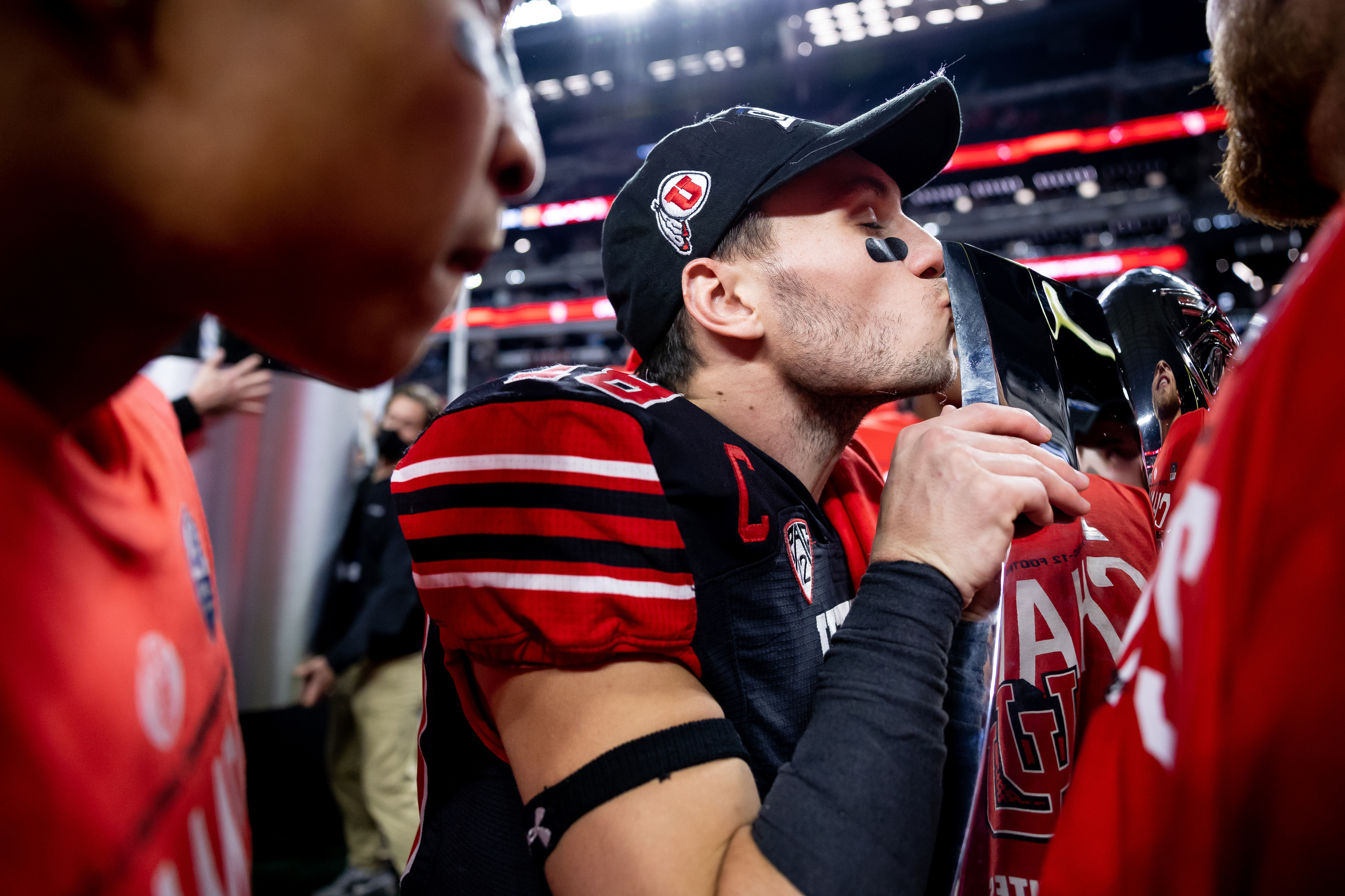 Utah Utes wide receiver Britain Covey (18) kisses the trophy after the Utes beat the Oregon Ducks in the Pac-12 championship game at Allegiant Stadium in Las Vegas on Friday, Dec. 3, 2021.