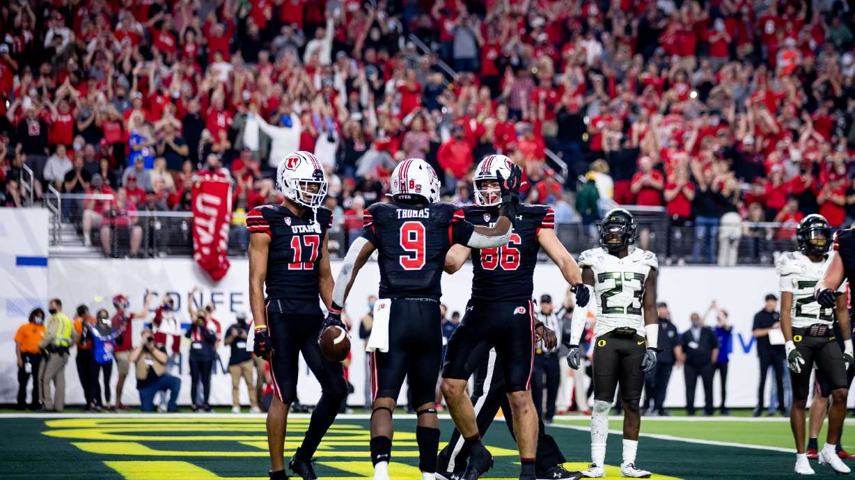 Utah Utes running back Tavion Thomas (9) celebrates with wide receiver Devaughn Vele (17) and tight end Dalton Kincaid (86) after Thomas ran for a touchdown during the Pac-12 championship game against the Oregon Ducks at Allegiant Stadium in Las Vegas on Friday, Dec. 3, 2021.