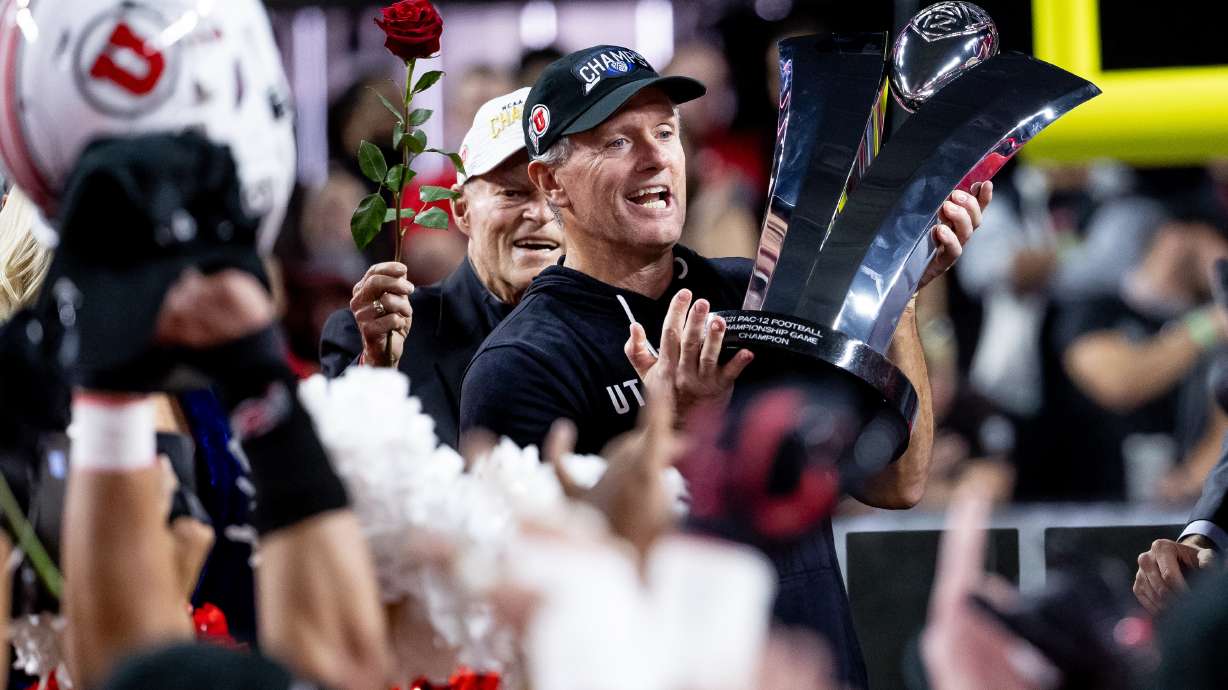 Utah Utes head coach Kyle Whittingham hoists the Pac-12 trophy after the Utes beat the Oregon Ducks in the Pac-12 championship game at Allegiant Stadium in Las Vegas on Friday, Dec. 3, 2021.