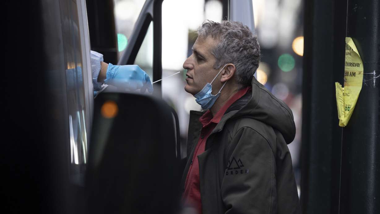 A person takes COVID-19 test at mobile testing site near Grand Central Terminal on Friday, Dec. 3, 2021, in New York. The omicron variant of COVID-19, which had been undetected in the U.S. before the middle of this week, had been discovered in at least five states by the end of Thursday, showing yet again how mutations of the virus can circumnavigate the globe with speed and ease.
