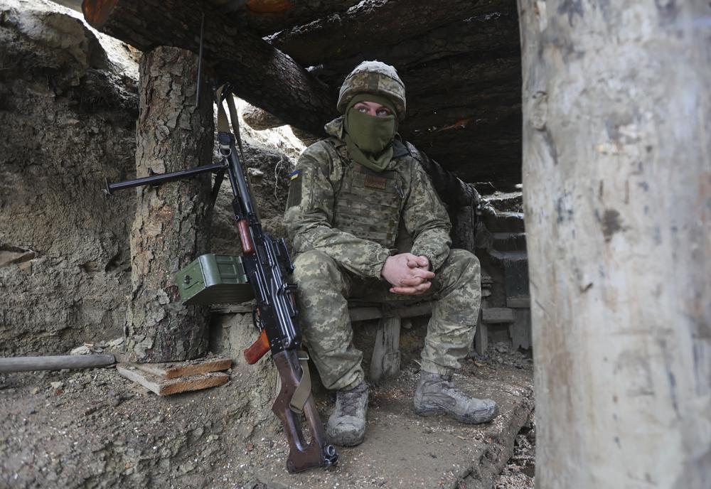 Ukrainian soldiers sits in a fighting position on the line of separation from pro-Russian rebels near Debaltsevo, Donetsk region, Ukraine, on Friday. The Ukrainian defense minister warned that Russia could invade his country next month. Russia-West tensions escalated recently with Ukraine and its Western backers becoming increasingly concerned that a Russian troop buildup near the Ukrainian border could signal Moscow's intention to invade.