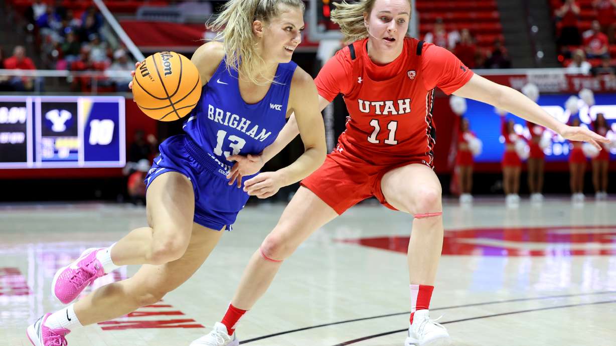 BYU Cougars guard Paisley Harding (13) drives on Utah Utes guard Brynna Maxwell (11) as Utah and BYU women compete in a basketball game at the Huntsman Center in Salt Lake City on Saturday, Dec. 4, 2021.