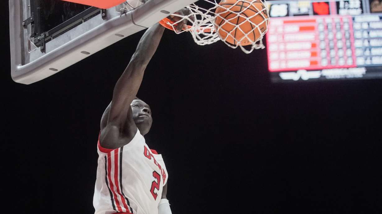 Utah guard Both Gach (2) dunks during an NCAA game against California Golden Bears at the Huntsman Center in Salt Lake City on Sunday, Dec. 5, 2021.
